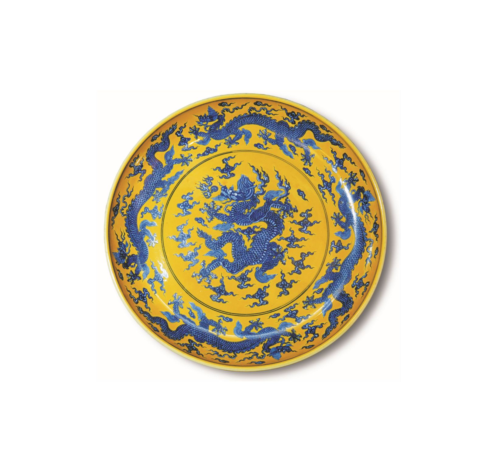a blue and white dragon dish on yellow ground a blue and white dragon dish on yellow ground