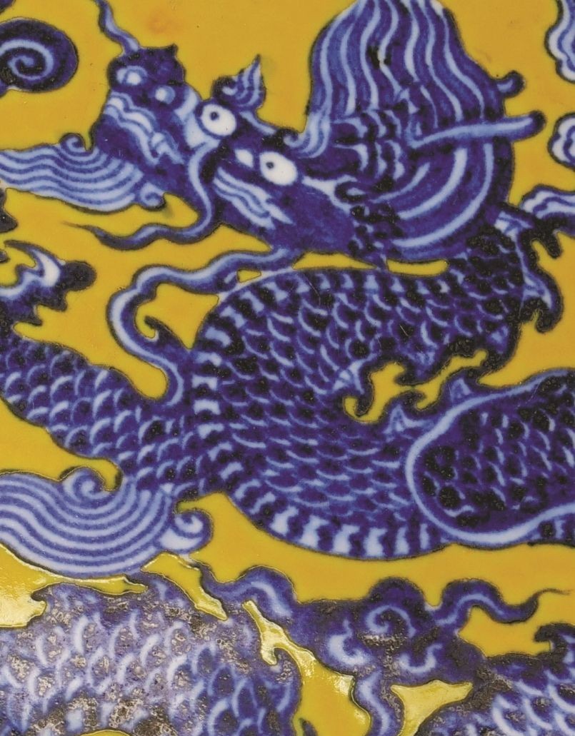 a blue and white dragon dish on yellow ground a blue and white dragon dish on yellow ground